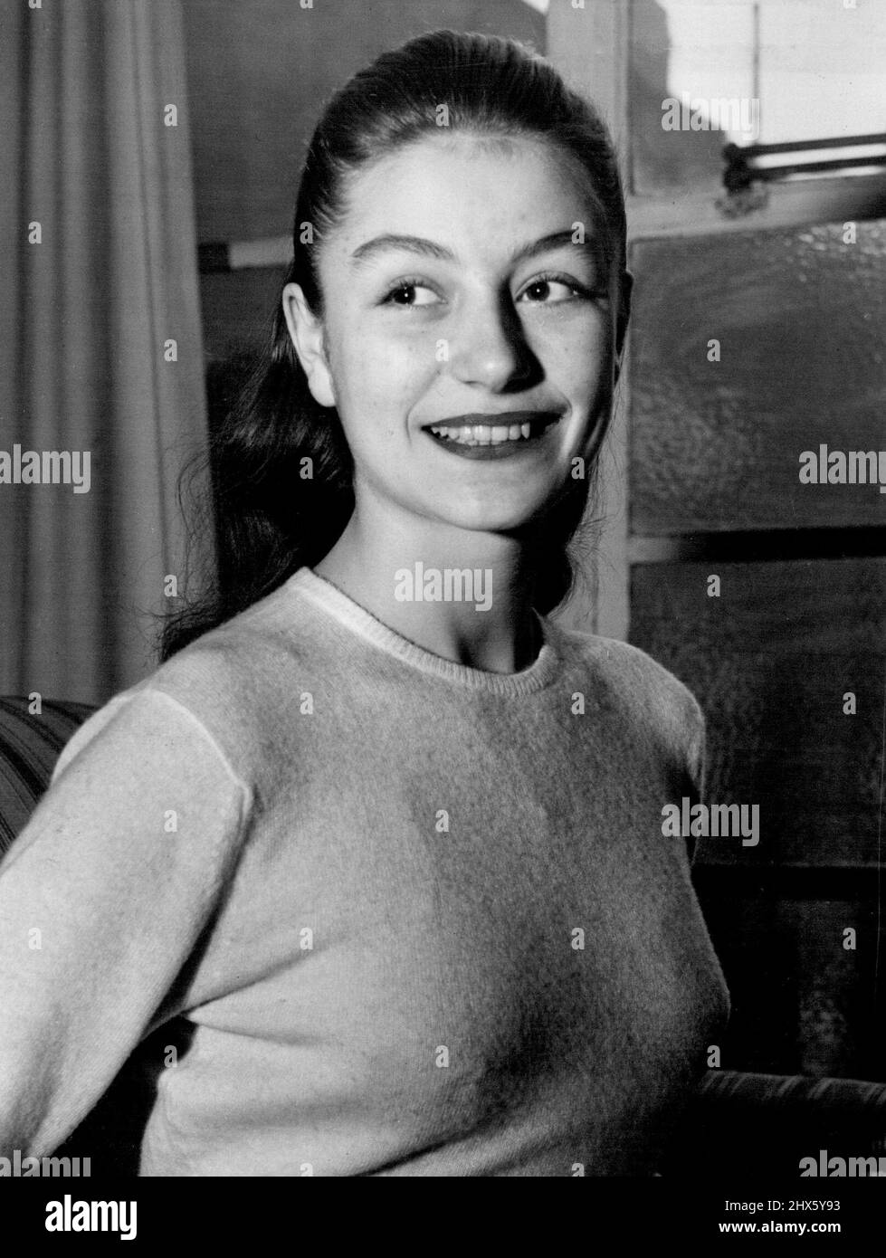 Starlet From France -- Young Parisier dark-haired Anouk Aimee wearing a very pleasing smile. Latest recruit to the J. Arthur Race Organisation is 16-years-old Anouk Aimee, of Paris. Anouk was at school in London, and therefore speaks English,but before she starts work on her new film, 'Golden Salamander' she will have a special governess to improve her accent. February 01, 1949. (Photo by Evening Newspapers).;Starlet From France -- Young Parisier dark-haired Anouk Aimee wearing a very pleasing Stock Photo