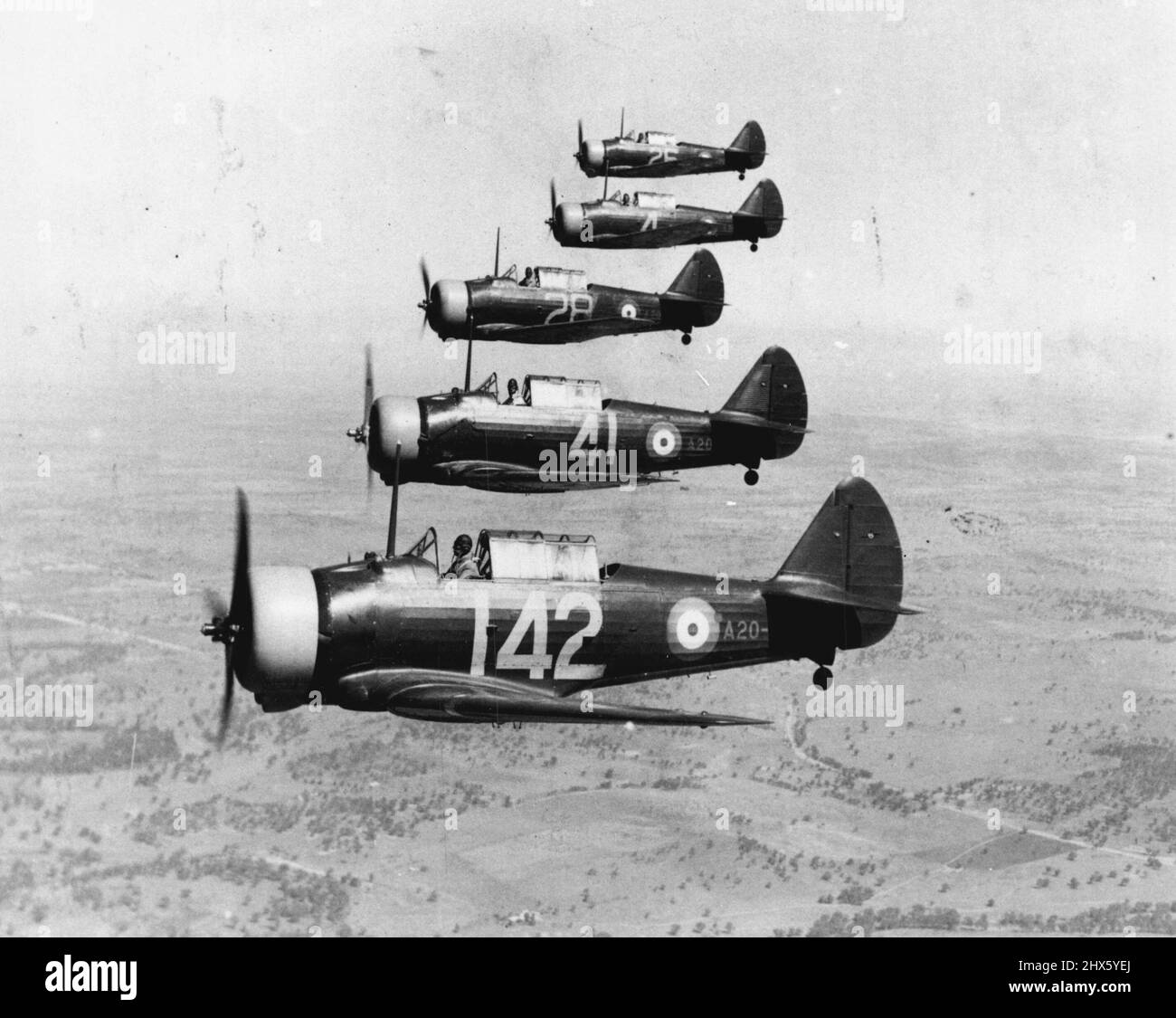 Wirraways, 5 in 'Echelon Right Stepped up' formation, at No. 2 Service flying Training School, Wagga Wagga (NSW). January 20, 1941. (Photo by John Harrison, Australian War Memorial).;Wirraways, 5 in 'Echelon Right Stepped up' formation, at No. 2 Service flying Training School, Wagga Wagga (NSW). Stock Photo