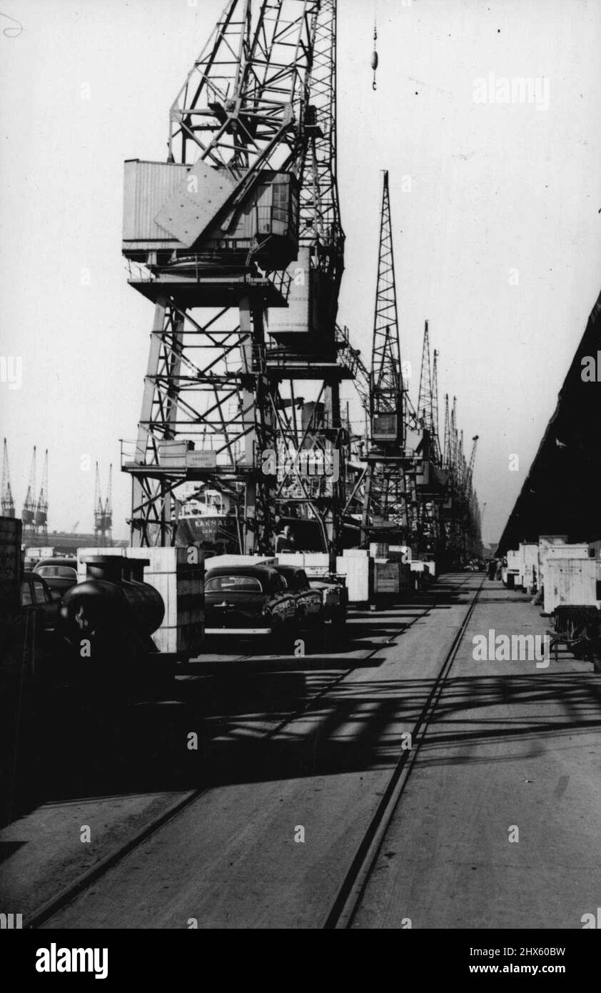 London Dock Strike -- Idle cranes and cargoes lying along the quays in the Royal Albert Docks, London. Over 20,000 men are now on strike and London's docks are almost completely paralysed. Quaysides and warehouses are stacked with cargoes awaiting shipment and ninety ships are so far held up. October 7, 1954. (Photo by Sport & General Press Agency, Limited).;London Dock Strike -- Idle cranes and cargoes lying along the quays in the Royal Albert Docks, London. Over 20,000 men are now on strike an Stock Photo