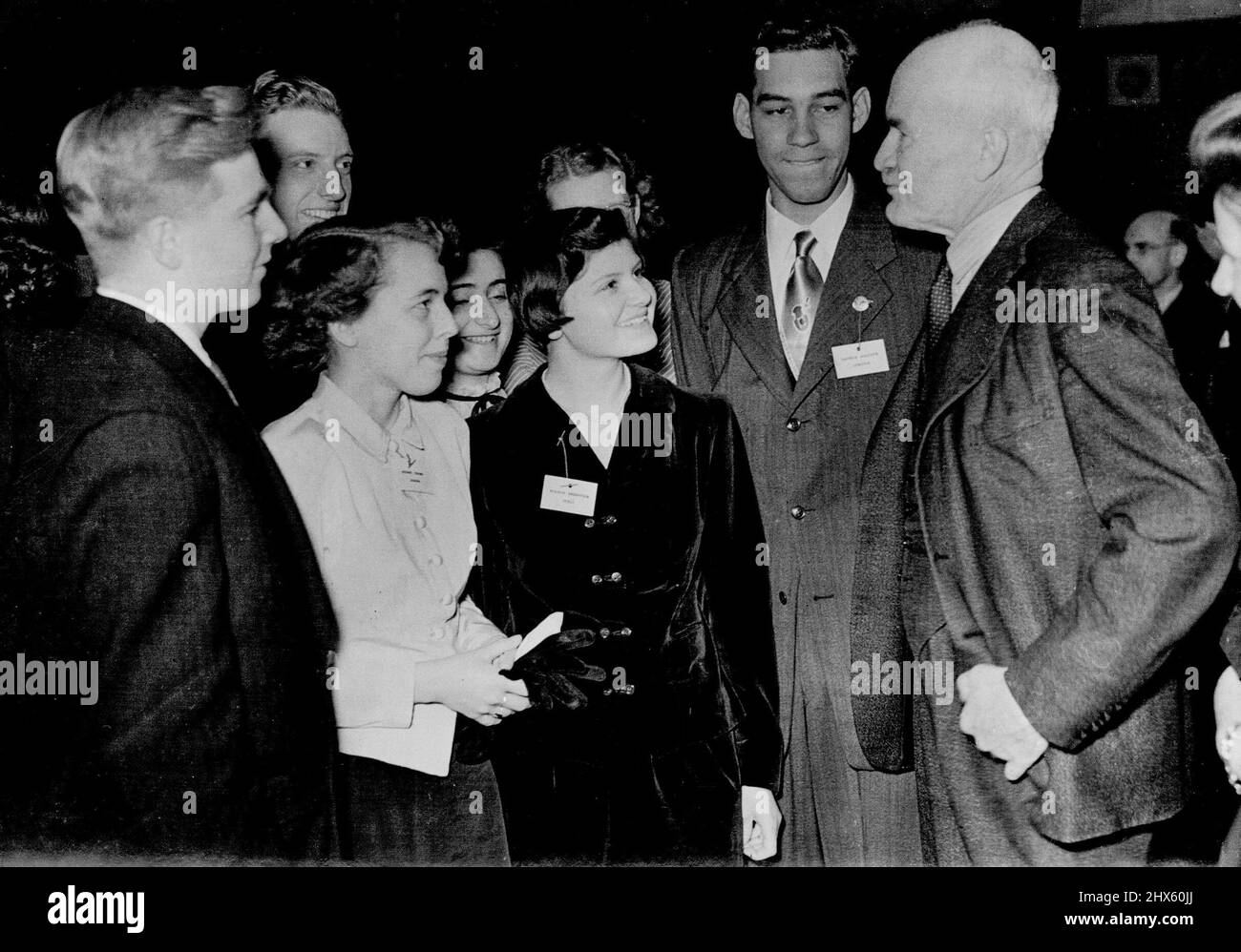 Reception To Daily Mail youth Foram At Hoare Memorial Hall -- Sir Ronald Adam Chairman of British council taking to Delegates of the youth Foram from all over the World. March 15, 1950. (Photo by Daily Mail Contract Picture).;Reception To Daily Mail youth Foram At Hoare Memorial Hall -- Sir Ronald Adam Chairman of British council taking to Delegates of the youth Foram from all over the World. Stock Photo
