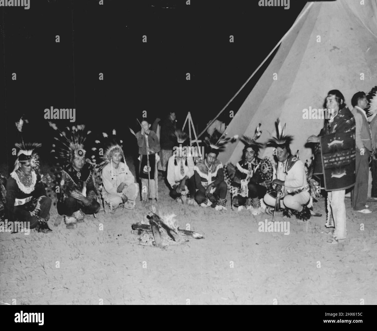 Trailing Antelope -- Dressed in full Regalia, Shoshone Indians squat ...