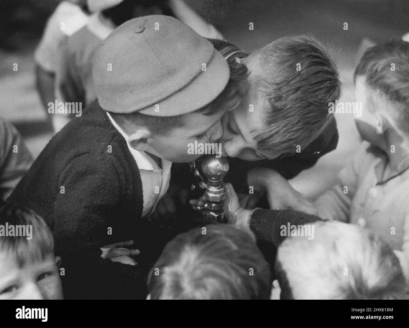 Thirst-Quencher for boys of the Erskineville Nursery School during their visit to the Botanic Gardens this morning. May 10, 1946.;Thirst-Quencher for boys of the Erskineville Nursery School during their visit to the Botanic Gardens this morning. Stock Photo