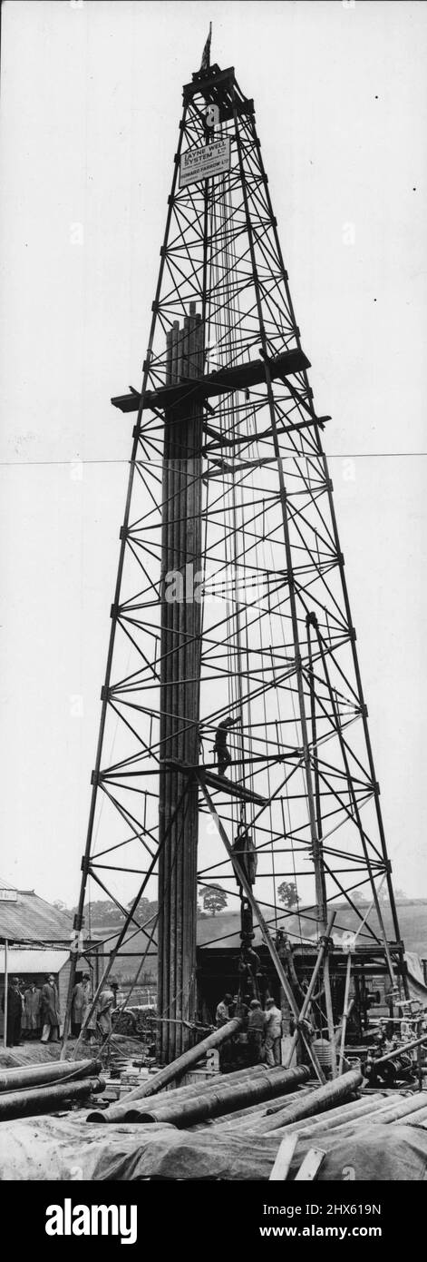 Croydon's 1,100 Foot Well -- A general view during the final operations at the borehole at Coombe Lane, Croydon. The final operation of placing into position the 45,000Ibs. of tubing in connected sections, each 20ft. long, of the new experimental borehole in Croydon's attempt to obtain water (from the green sand lying far below the chalk basin from which London's artesian well supplies are drawn). This is a new and hitherto untouched water supply, which is claimed to be capable ultimately of yie Stock Photo