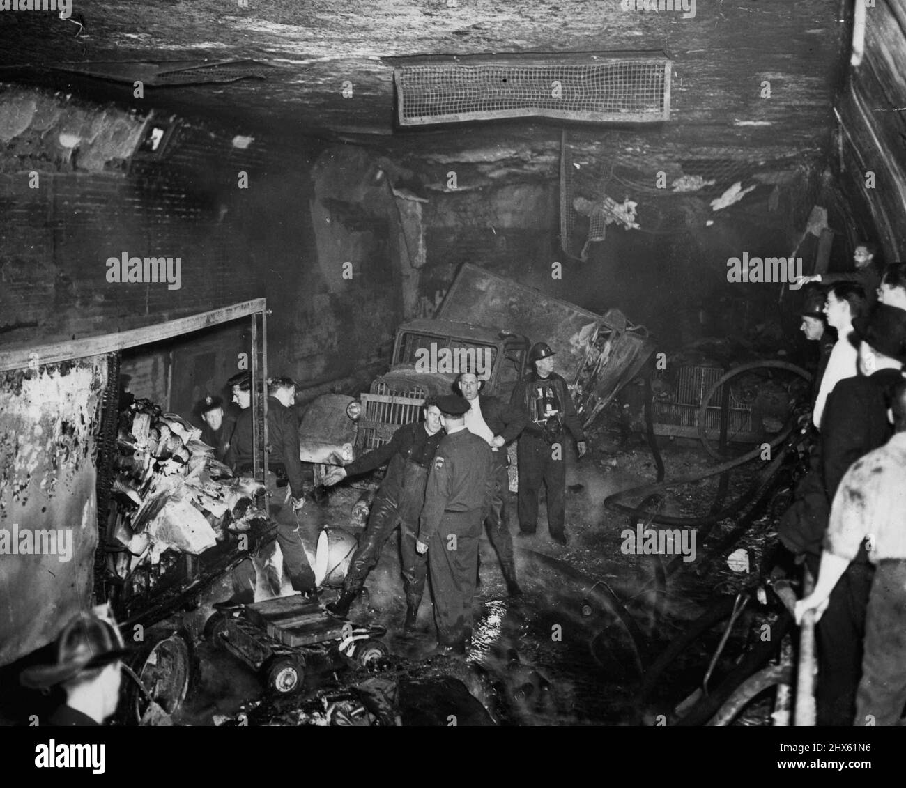 Trucks Blast Rips Holland Tunnel. Debris Litters the Holland Tunne's east bound tube, May 13, following an explosion of drums of chemicals on a truck. The explosion was touches off when the truck (center) caught fire near the New Jersey end of the Tunnel. Flames spread to other trucks and the under water highway was filled with carbon disulphide fumes. Firemen wearing gas masks brought the fire under control. May 13, 1949. (Photo by Associated Press Photo).;Trucks Blast Rips Holland Tunnel. Debr Stock Photo