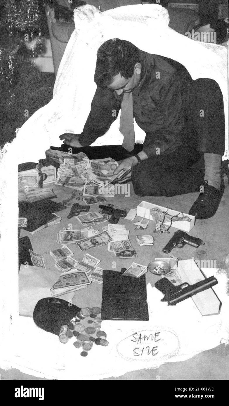 Valuable Haul By C.I.D. In Berlin -- A C.I.D. Agent counting English round notes found with the other valuables seen in picture. Some 10,000 Dollars worth of German, French Belgian and English, notes, Jewellry, Pistols, Gold, etc., were found in the possession of a civilian who was arrested by Criminal investigation Department agents in Berlin. it is Believed that the valuables formed part of Black Market transactions. January 14, 1946. (Photo by Associated Press Photo). ;Valuable Haul By C.I.D. Stock Photo