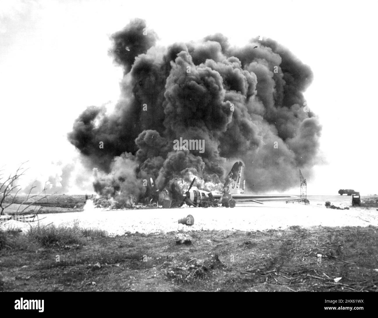 B-29 Burns After Jap Attack on Saipan - An American B-29 superfortress burns on Saipan Island, in the Marianas, after Jap planes strafed the airfield. December 27, 1944. (Photo by Associated Press Photo).;B-29 Burns After Jap Attack on Saipan - An American B-29 superfortress burns on Saipan Island, in the Marianas, after Jap planes strafed the airfield. Stock Photo