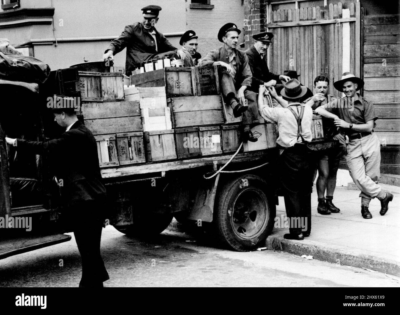 Customs Officers about leave with the first lorry wood of seized liquor at North Sydney today. December 13, 1943. (Photo by Barry Newberry/Fairfax Media).;Customs Officers about leave with the first lorry wood of seized liquor at North Sydney today. Stock Photo