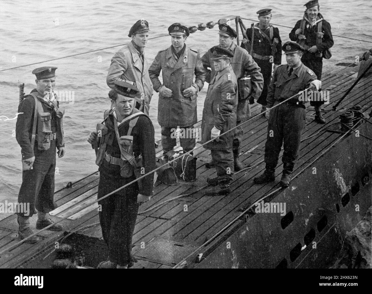 The First German U-Boat Surrenders At Weymouth - The German officers on board the U 249 after the surrender, and guarded by men of the Polish Navy. The first German U-boat - the U 249 surrendered and was taken in charge by the British Navy off Weymouth, Dorset. Five German officers of Ober-Lieut. Kock, were on board when Commander N.J. Weir, R.N., went on board to received the surrenders. May 11, 1945. (Photo by Andrews Planet).;The First German U-Boat Surrenders At Weymouth - The German officer Stock Photo