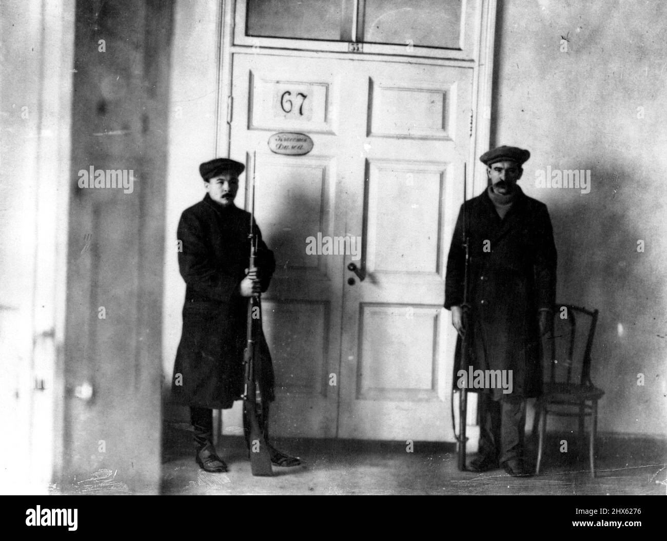 Street Fighting In Petrograd -- Lenin's guardians. They are seen outside the ***** of the room in which he transacts his business. February 19, 1918. (Photo by Daily Mirror).;Street Fighting In Petrograd -- Lenin's guardians. They are seen outside the ***** of the room in which he transacts his business. Stock Photo