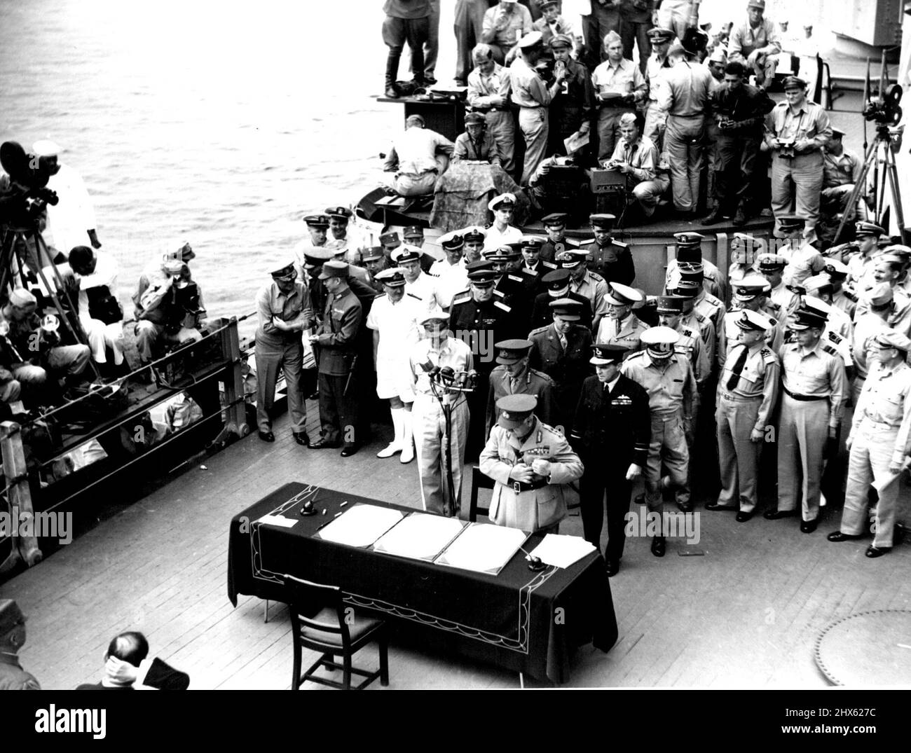 Surrender In Tokyo Bay -- General Sir Thomas Blamey with other Australian representatives behind him arrives at the table to sign the surrender document on behalf of Australia. The singing took place in Tokyo Bay on board Admiral Nimitz's Flaship USS 'Missouri' Note left foreground the Japanese General Yoshijiro Umezo and Mr. Mamoru Shigemitsu (with hand to head), the signatories for Japan. September 10, 1945. (Photo by Australian Official Photo).;Surrender In Tokyo Bay -- General Sir Thomas Bla Stock Photo