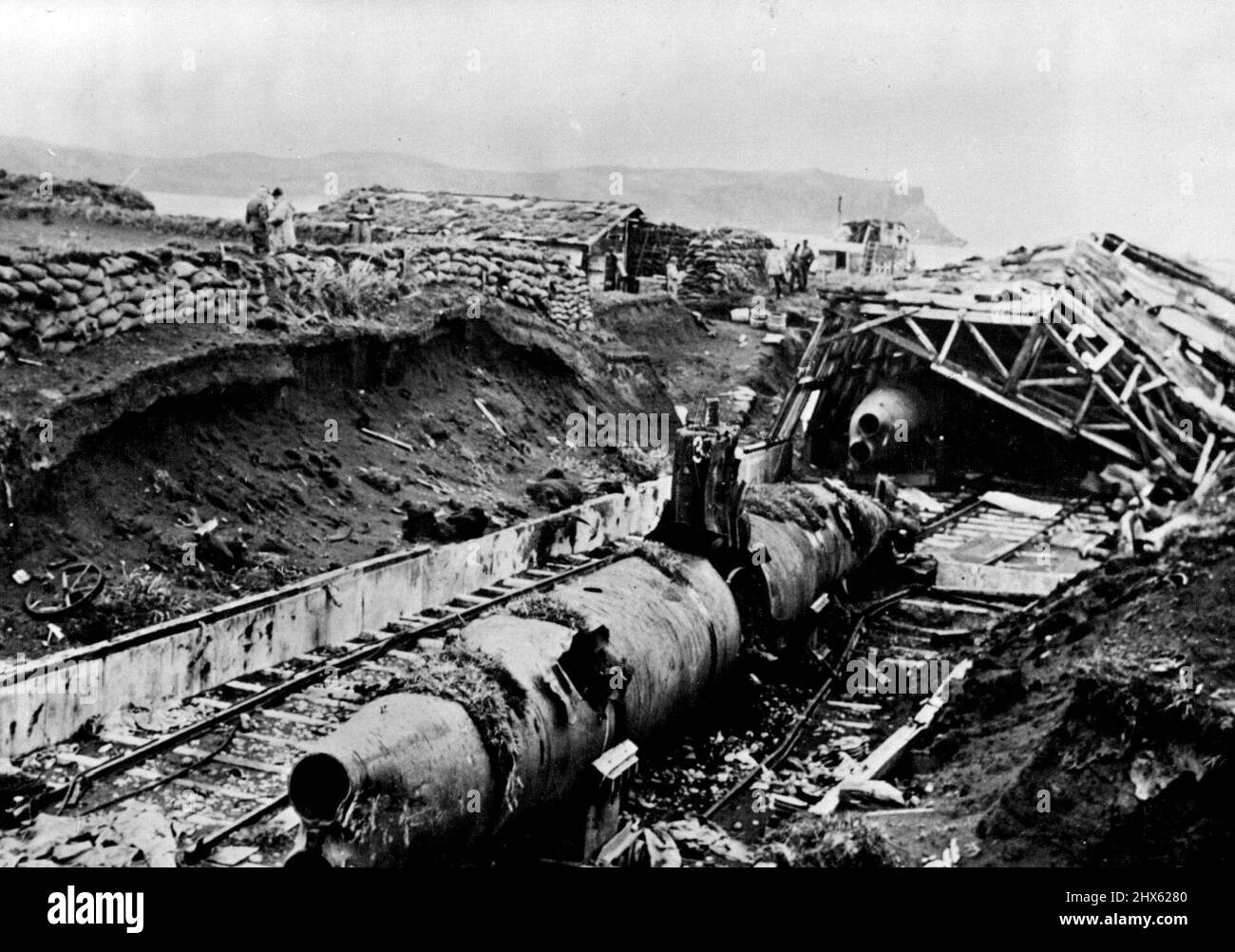 Japanese Submarines Wrecked On Kiska -- Japanese minature submarines were found wrecked on Kiska Island, in the Aleutian chain, by American and Canadian forces who landed without opposition to take possession of the North Pacific base on Aug. 15. Heavy bombardment by sea and air forced the Japanese to flee from Kiska, their last stronghold on North American territory; The demolished submarine shed shown was located a mile from a former enemy camp on the Island. January 1, 1943. ;Japanese Submari Stock Photo