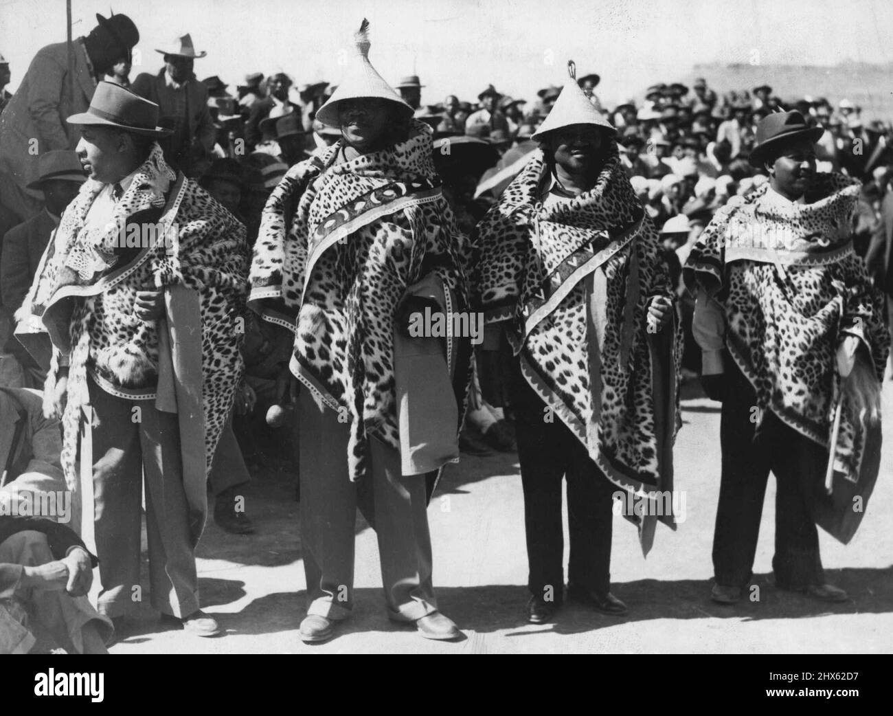 The Royal Family In Basutoland -- The four senior chiefs in their leopard skins make very colourful figures at the Royal Pitso held at Maseru on March 13th. The Royal Pitso arranged in honour of the visit of their Majesties and the two Princesses was attended by a huge concourse of Basuto natives headed by their Regent, Paramount Chieftainess Mantsebo Seeiso, many chiefs and thousands of natives. It is estimated that about 80,000 were assembled to greet the royal party. They had been arriving f Stock Photo