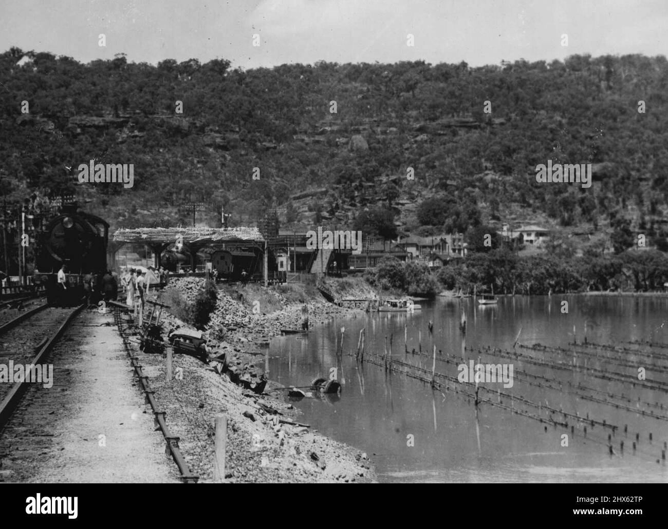 Tragic Level - Crossing smash at Hawkesbury River, NSW., When the Kempsey Mail train crashed into a bus at a level-crossing near Hawkesbury River (NSW) station on January 20, 16 bus passengers were killed. Four members of one family were among the victims. The bus was cut in halves and smashed to matchwood. One section with several bodies was carried 400 yards by the locomotive, the tender of which was derailed. The engine is shown above. January 25, 1944. (Photo by Associated Newspapers Ltd.). Stock Photo