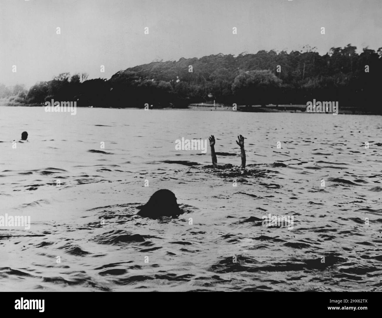 ***** but the arms of the drowning person appears above ***** but help is coming. March 21, 1942. (Photo by C. Anders & Co.). Stock Photo