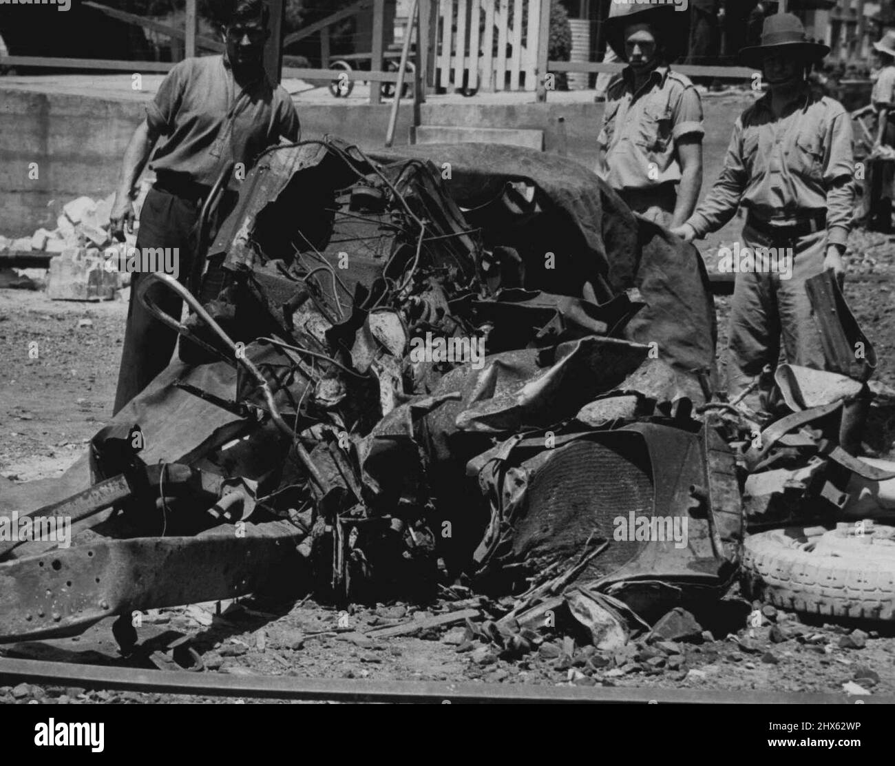 Tragic Level - Crossing smash at Hawkesbury River, NSW., Tangled mass of fragments of the bus which was struck by the Kempsey mail train at Hawkesbury River, NSW, on January 20. The steering wheel can be seen to the left. Eye-witnesses say they had never before seen a vehicle so completely pulped. Sixteen bus passengers lost their lives. January 25, 1944. (Photo by Associated Newspapers Ltd.). Stock Photo