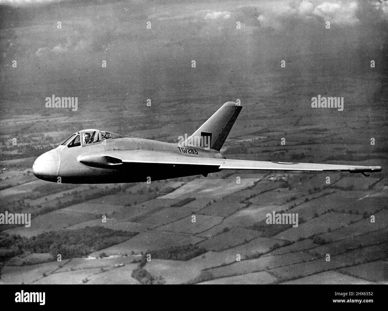 Britain To Go Over To All-Jet Aircraft - Experiments With DH 108. The new DH 108 jet-propelled single-seater research plane in flight over Hatfield airfield: Mr. Geoffrey de Havilland, the designer, is the pilot. Britain, already ahead of other countries in the development of jet propulsion motors, is on the threshold of a new era in civil aviation. All now British planes, both military and civil, are to befitted with pure-jet or gas-turbine engines driving propellers, which represents a big sto Stock Photo