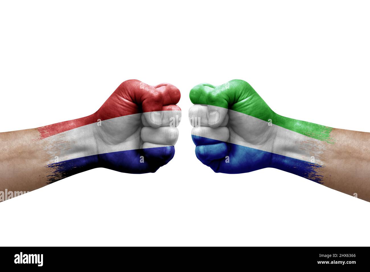 Two hands punch to each others on white background. Country flags painted fists, conflict crisis concept between netherlands and sierra leone Stock Photo