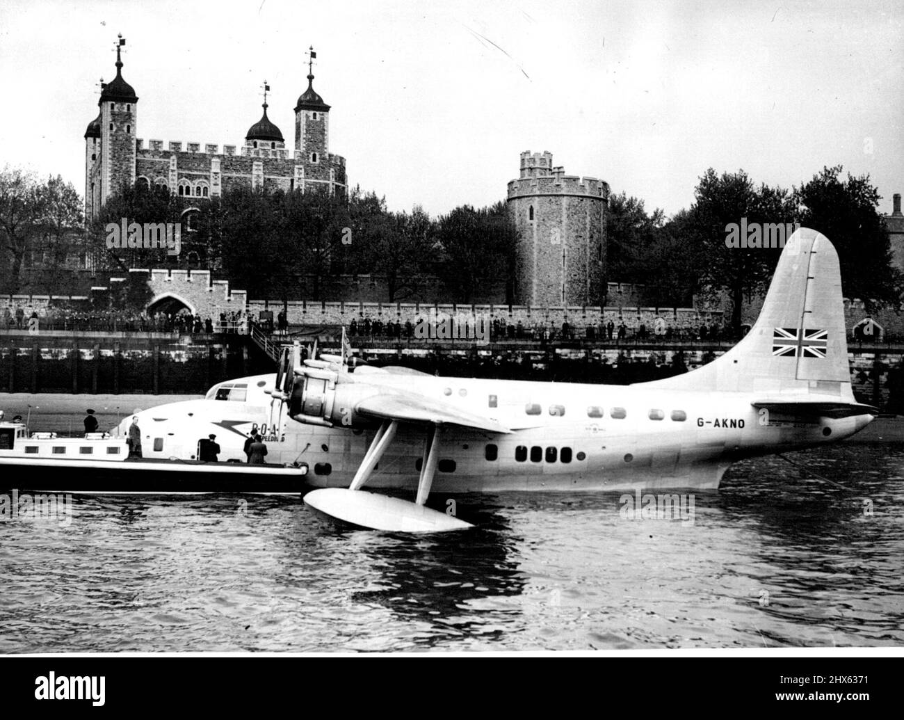 Flying Boat Moored on Thames. Moored at Tower Pier with the Tower of London in the background. The London Thames carried a different boat yesterday this 35-ton Short Solent, largest of Britain's commercial flying boats. The Solent, first flying boat to land in the London area for twenty-one years, touched down at Limehouse Reach and taxied up the river through the Tower Bridge. The bridge was raised to make sure the Solent's high tall did not foul it. She was finally moored near Tower Bridge. Ma Stock Photo