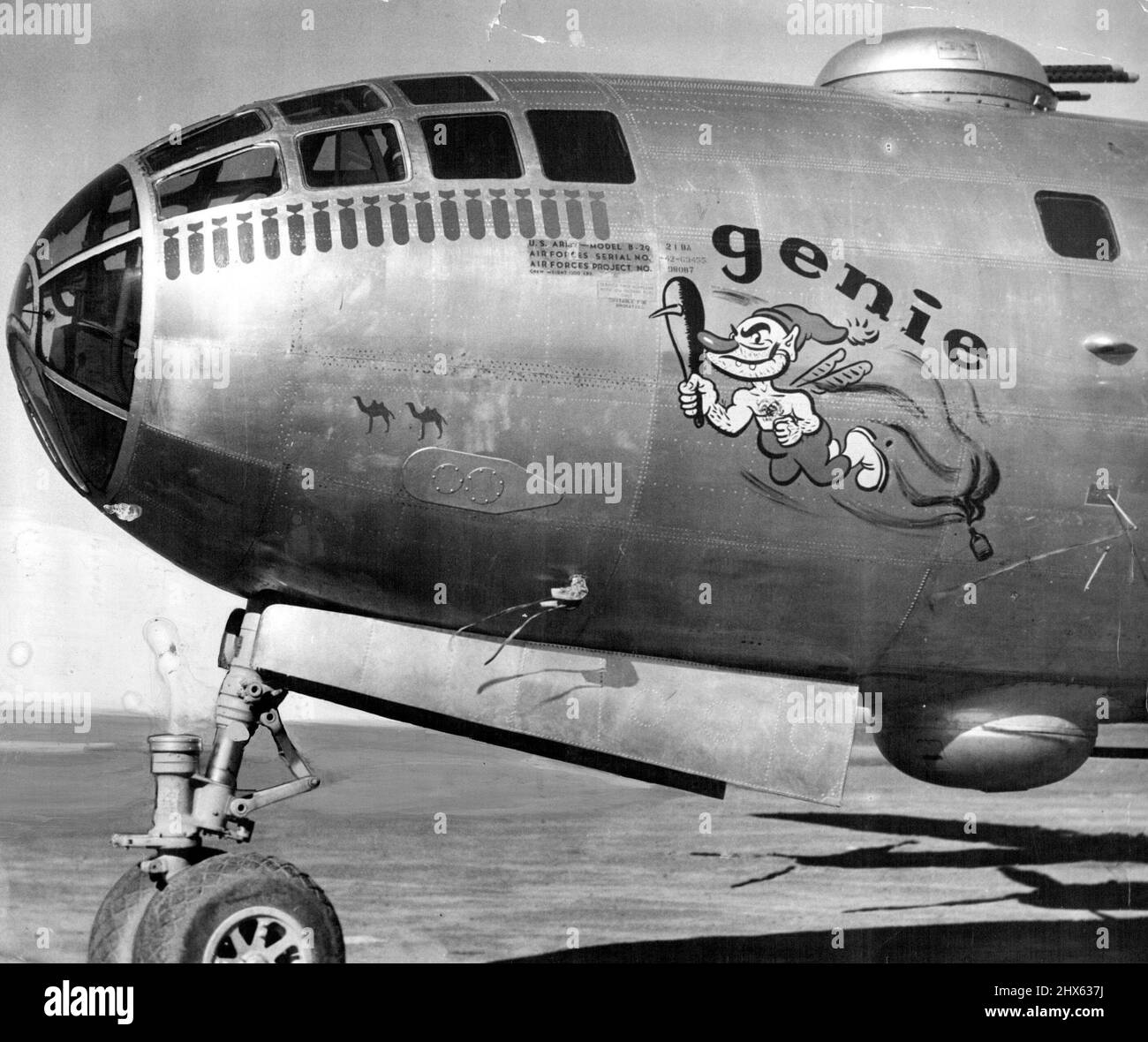 Decorated with a representation of a genie emerging from a bottle, the U.S. Super-Fortress Genie, now at Mascot, is decorated with painted bombs to indicate the number of bombing raids she has made over targets in Japan. June 24, 1945. Stock Photo