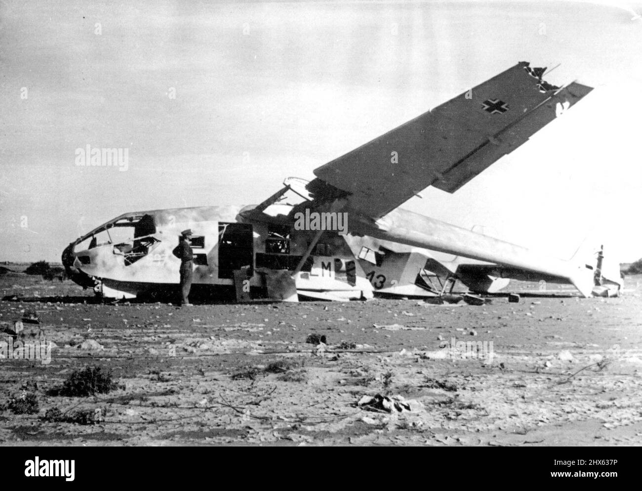 Exterior of A German Troop carrying glider damaged by R.A.F. bombing an aerodrome in the Western desert. Even allowing for the increased appearance of size created by the camera's perspective, this photo gives a fairly accurate idea of the size of these troop carrying gliders. January 14, 1943. (Photo by Sport & General Press Agency, Limited). Stock Photo