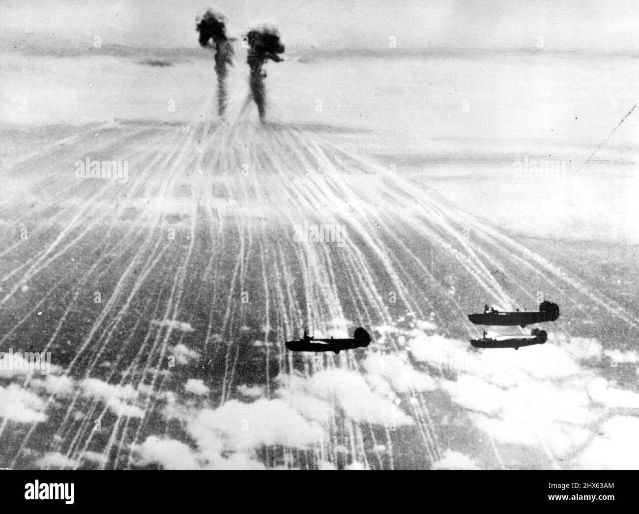 Two Japanese phosphorus bombs burst harmlessly near a formation of Liberators returning from a raid on the Volcano Islands, which are only 6CG miles from the Japanese mainland. October 26, 1944. (Photo by U.S. Office of War Information Picture). Stock Photo