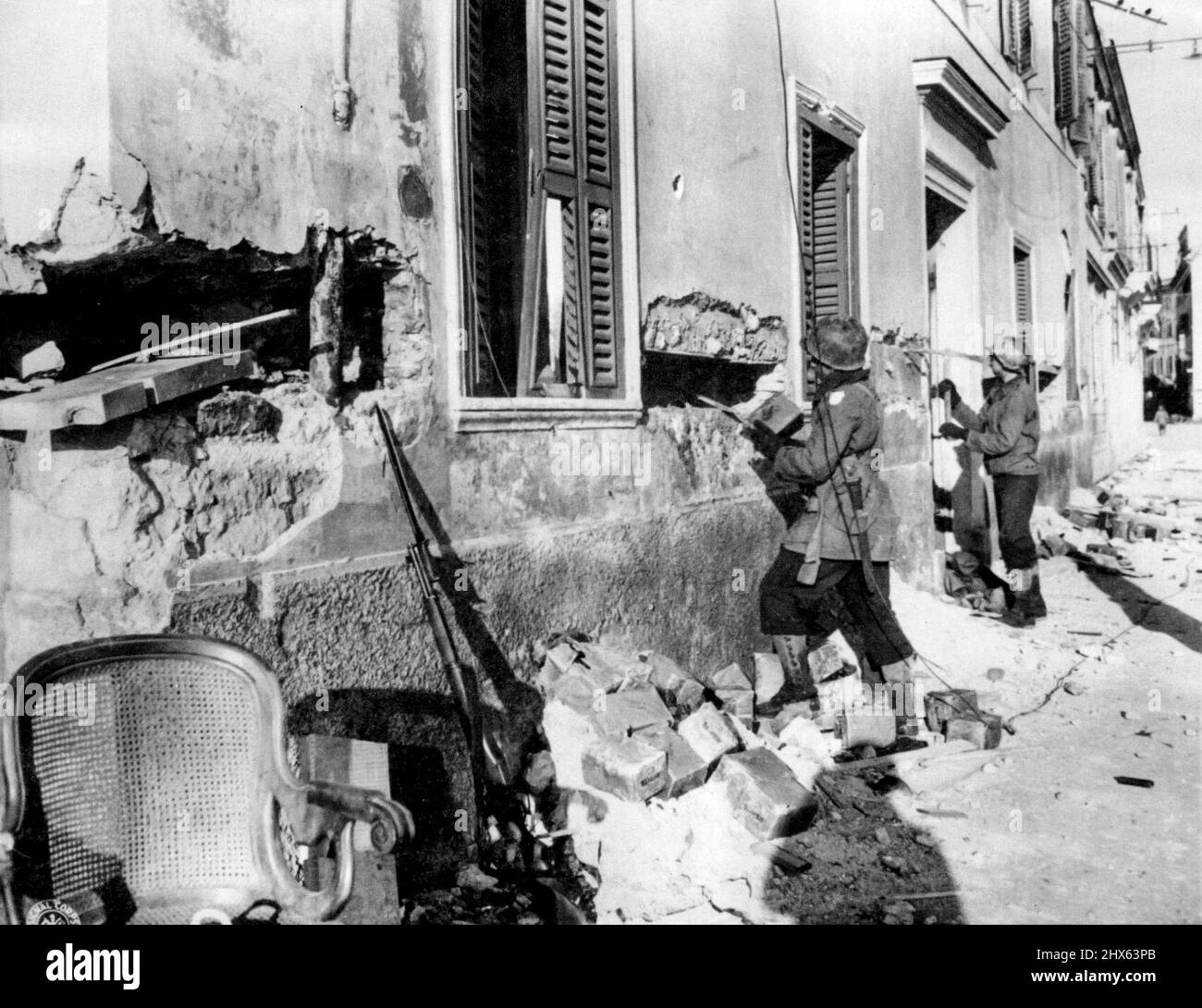 Yanks Remove Explosives in Anzio: U.S. Army engineers dig out explosives buried in the sides of a building beside the docks at Anzio by Germans with the intention of blocking the docks to use by allies at newest Italian beachhead. February 29, 1944. (Photo by Associated Press Photo). Stock Photo