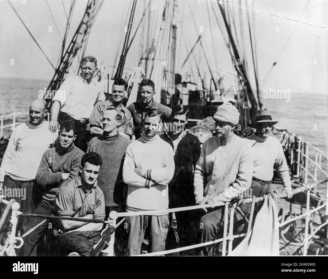 Home from Antarctic Seas: Members of the scientific staff of B.A.N.Z. Antarctic Research Expedition who arrived in Adelaide on 1 April after an extensive cruise in Antarctic and Sub-Antarctic Seas. Sitting in front ... A. Howard. First row L to R ... R. G. Simmers, Sir Douglas Mawson, Com. Morton H. Moyes. Back Row L to R .,.. H. O. Fketcher, R. A. Falla, S.A.C. Campbell. April 15, 1930. (Photo by Captain Frank Hurley, The Herald Feature Service). Stock Photo