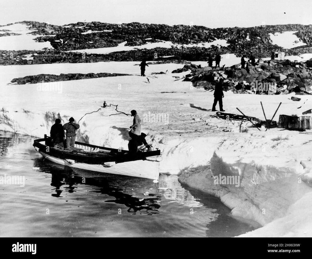 Mawson revisits former winter Quarters. After a lapse of 18 years Sir Douglas Mawson revisited the old winter quarters of his Australian Antarctic Expedition of 191101914. A landing is being made at Cape Denison, King George the Fifth Land. May 19, 1931. (Photo by Captain Frank Hurley, Herald Feature Service). Stock Photo