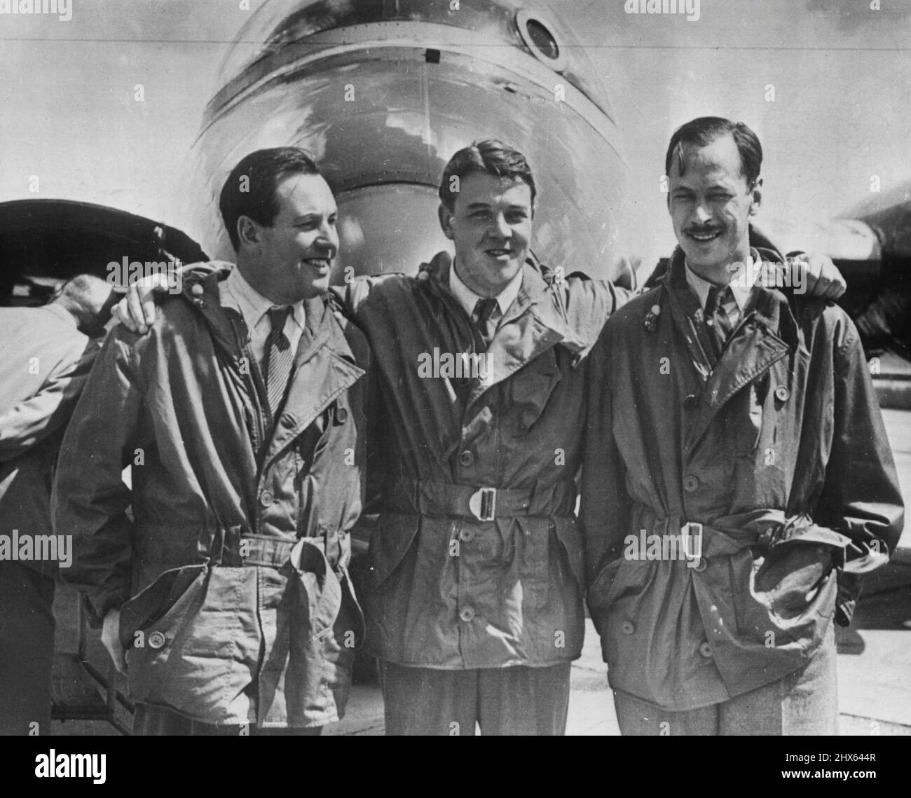 Crew Of Record Breaking Canberra -- The crew of the English Electric Canberra pose after Landing at the Olenn L. Martin plant here today. From left they are R.H. Rylands, R.P. Beamont, and D.A. Watson. The twin-jet Canberra Bomber set an East-West Atlantic crossing record last week. It made the 2,072.79-mile trip in four hours and 15 minutes. September 4, 1951. (Photo by AP Wirephoto). Stock Photo