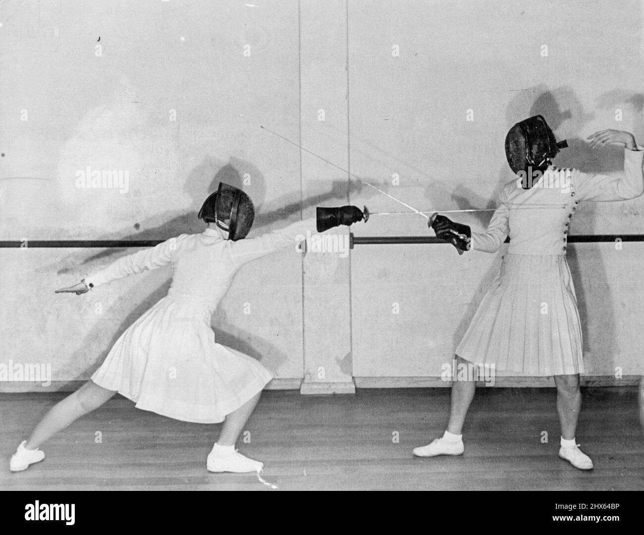 Lunge and Parry of Quatre. Hands and arms plays an important part in fencing They act as a tail does to a cat keeps the body in position. When the arms is thrown backward and downward it throws the body forward when the arm is brought up the body is bought quickly back to upright position. April 2, 1948. Stock Photo