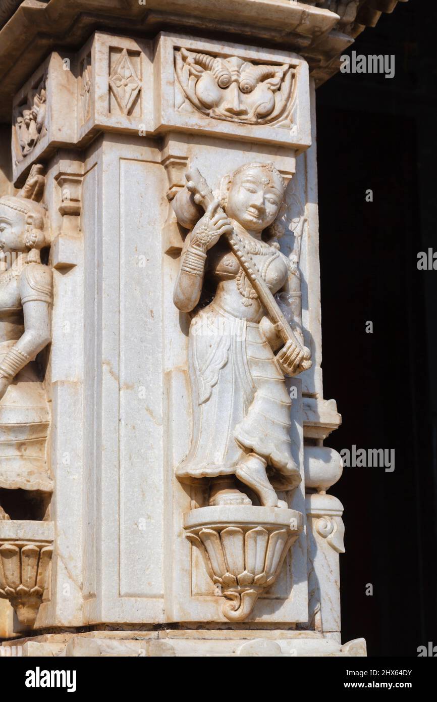 Wall carvings of a female figure with a musical instrument in the Hindu Shree Jagat Sheromani Ji Temple, Udaipur, Indian state of Rajasthan, India Stock Photo