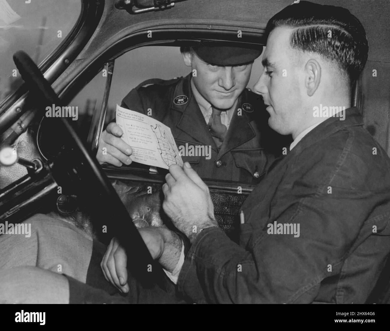 Questionnaire for driver Traffic officer hands this car driver a card on which he must detail his movements by car during the day. May 23, 1947. Stock Photo