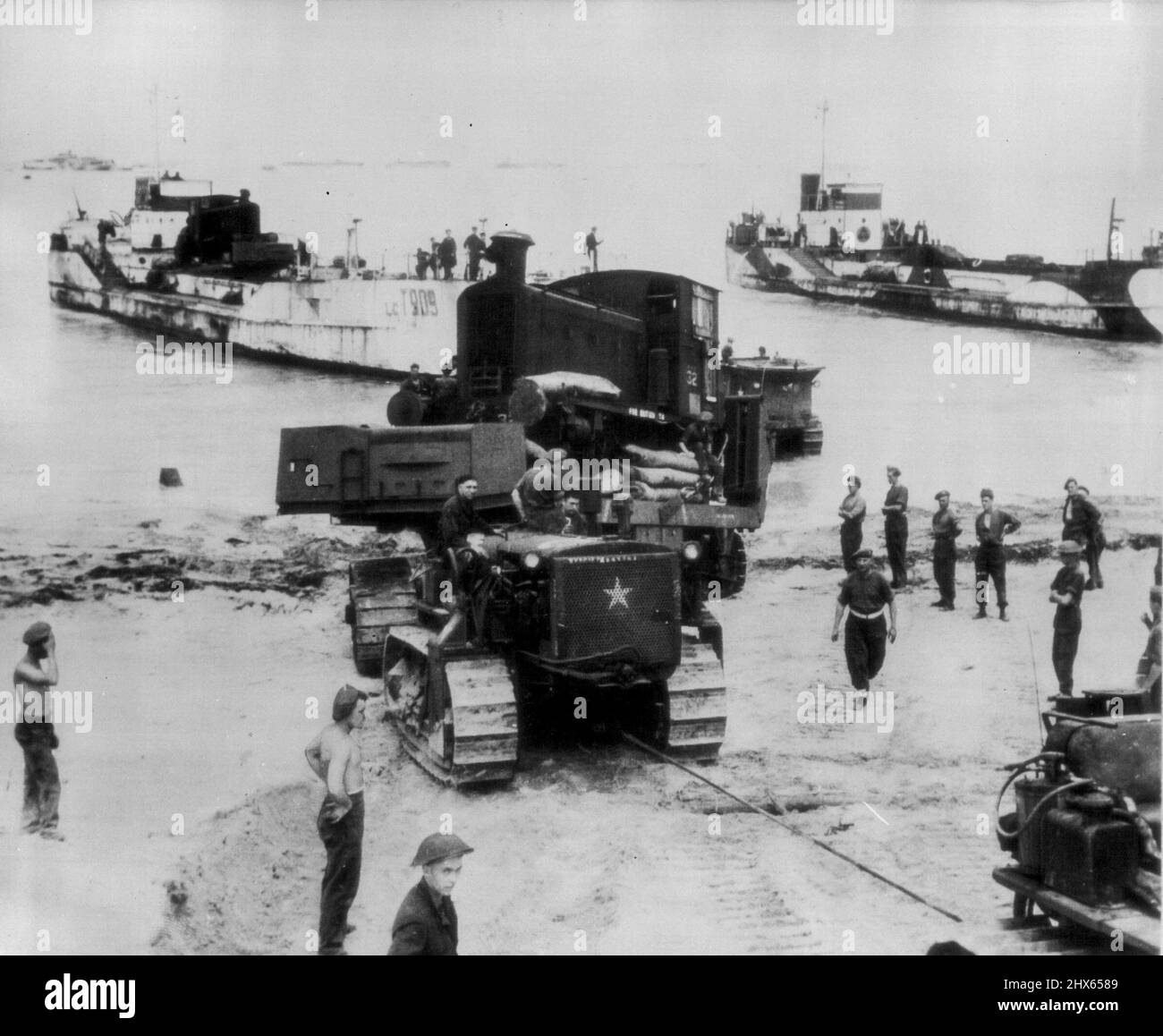 Iron Horses Reach Normandy -- Diesel railroad engines are brought ashore from landing craft in Normandy, France, to aid in the handling of supplies over captured railways. August 1, 1944. (Photo by AP Wirephoto). Stock Photo