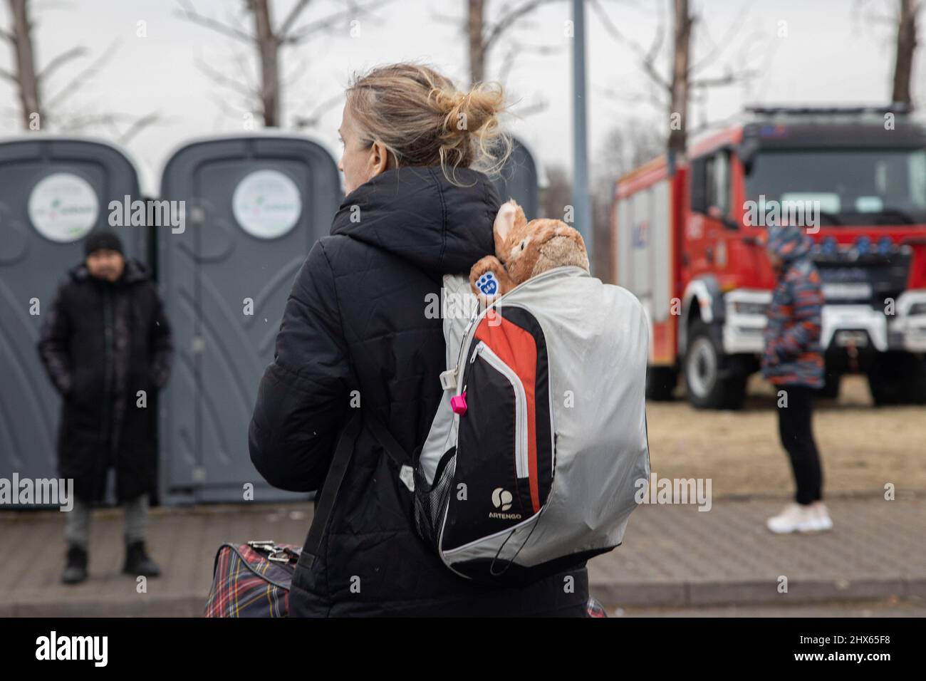 Przemysl, Poland. 09th Mar, 2022. A refugee seen with a soft toy in her backpack.A temporary refugee reception centre has been set up at a former Tesco warehouse on the outskirts of Przemy?l to shelter hundreds of thousands of Ukrainian refugees fleeing through the Medyka-Shehyni border. Credit: SOPA Images Limited/Alamy Live News Stock Photo