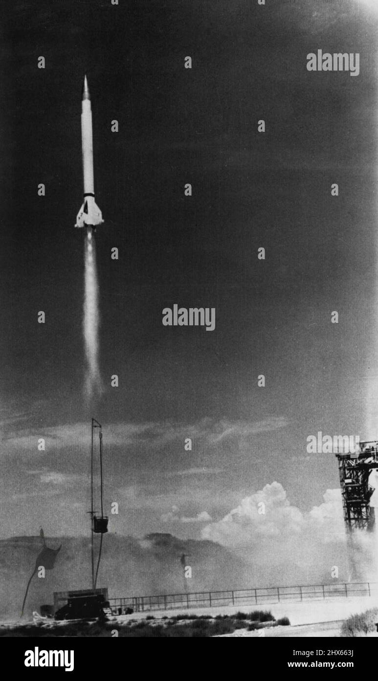 On Way To Record -- Viking rocket No. 7 roaring up 100 feet in air on way toward 135 mile altitude record at Navy proving ground. In background is gantry used to prepare rocket for shoot and San Andres mountains of southern New Mexico. August 07, 1951. (Photo by AP Wirephoto). Stock Photo