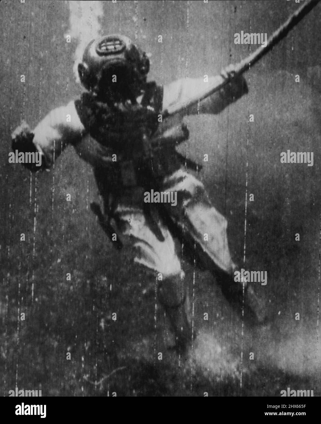 On Bottom Of Bikini Lagoon -- This Navy diver stirs up coral 'Dust' as he hits bottom at 162 feet in Bikini Lagoon while working on preparations for the forth coming Atom Bomb test scheduled for July *****. This joint Army Navy task force 1 photo was radioed by the Navy From the U.S.S. Mount McKinley at Bikini to San Francisco today. On the floor of Bikini lagoon, this US Navy diver stirs up coral 'dust' 162 feet below the surface while working on preparations for recent Atom-Bomb test. June 3 Stock Photo