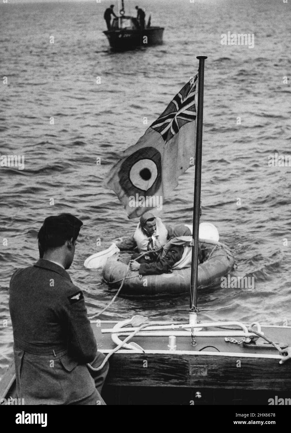 Airborne Lifeboat Service -- Pulling a ***** dinghy alongside one of the launches. The unceasing Air Battle of Britain has resulted in the formation of the Air-Sea Rescue Service operated by fleets of 40m.p.h. R.A.F. and Naval speed launches, and Lysander airplanes specially detauled for the duty. The task of the Service is to rescue British airmen who have been forced ***** to salvage their aircraft *****. August 18, 1941. (Photo by London News Agency Photos). Stock Photo