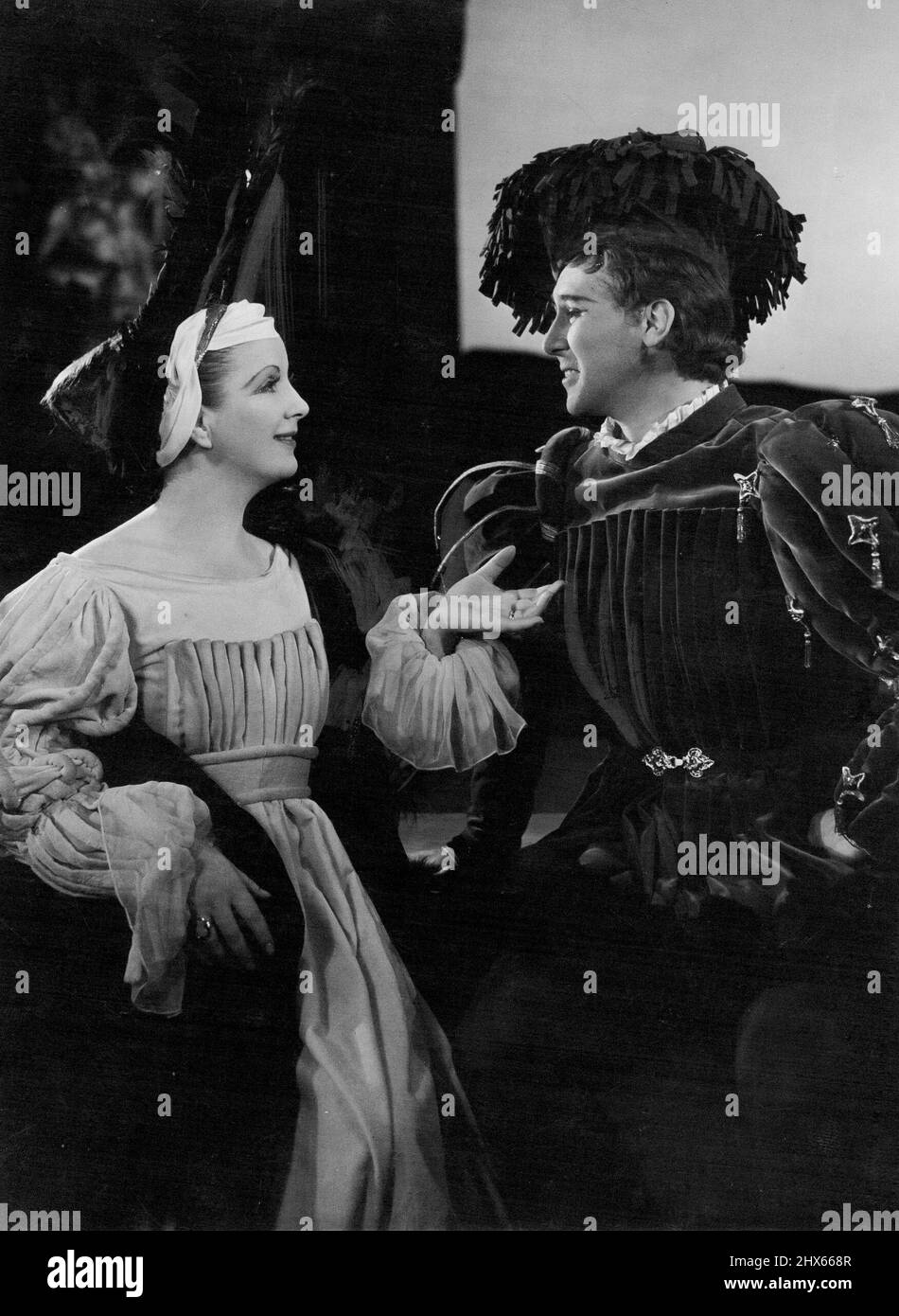 Diana Wynyard as Beatries and Anthony Quayle as Benedick in John Gielgud's production of 'Much Ado About Nothing'. This play, with 'Margaret' and 'Henry VIII' will tour Australia & New Zealand at the end of the present season at Stratford-upon-Avon. July 18, 1949. (Photo by Angus McBean). Stock Photo