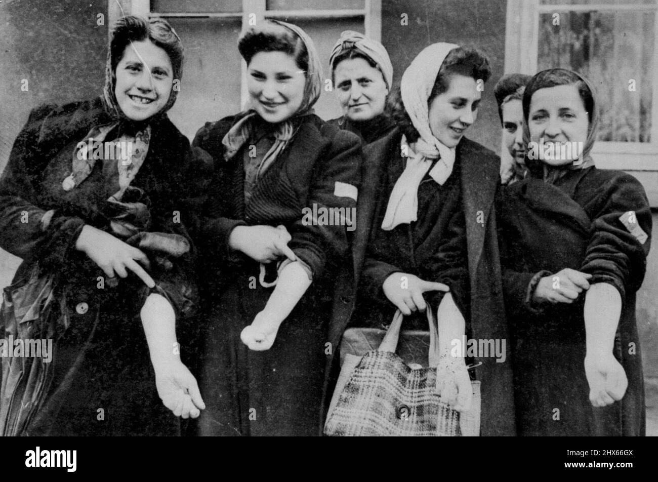 First Jewish Slave Girls Camp Liberated -- These sturdy Jewish girls, were taken to the slave workers camp at Kaunitz, Germany, were liberated by the 9th., Army. They were forced by the Nazis to work in a German munition factory. They come from Italy, France, Holland, Belgium, Poland, Csechoslovakia, etc.,, Each has a yellow cross on the back, and everyone of them, even the children have been tattooed on the left arm with their numbers. The yellow was just dabbed on with a paint brush by the Ger Stock Photo