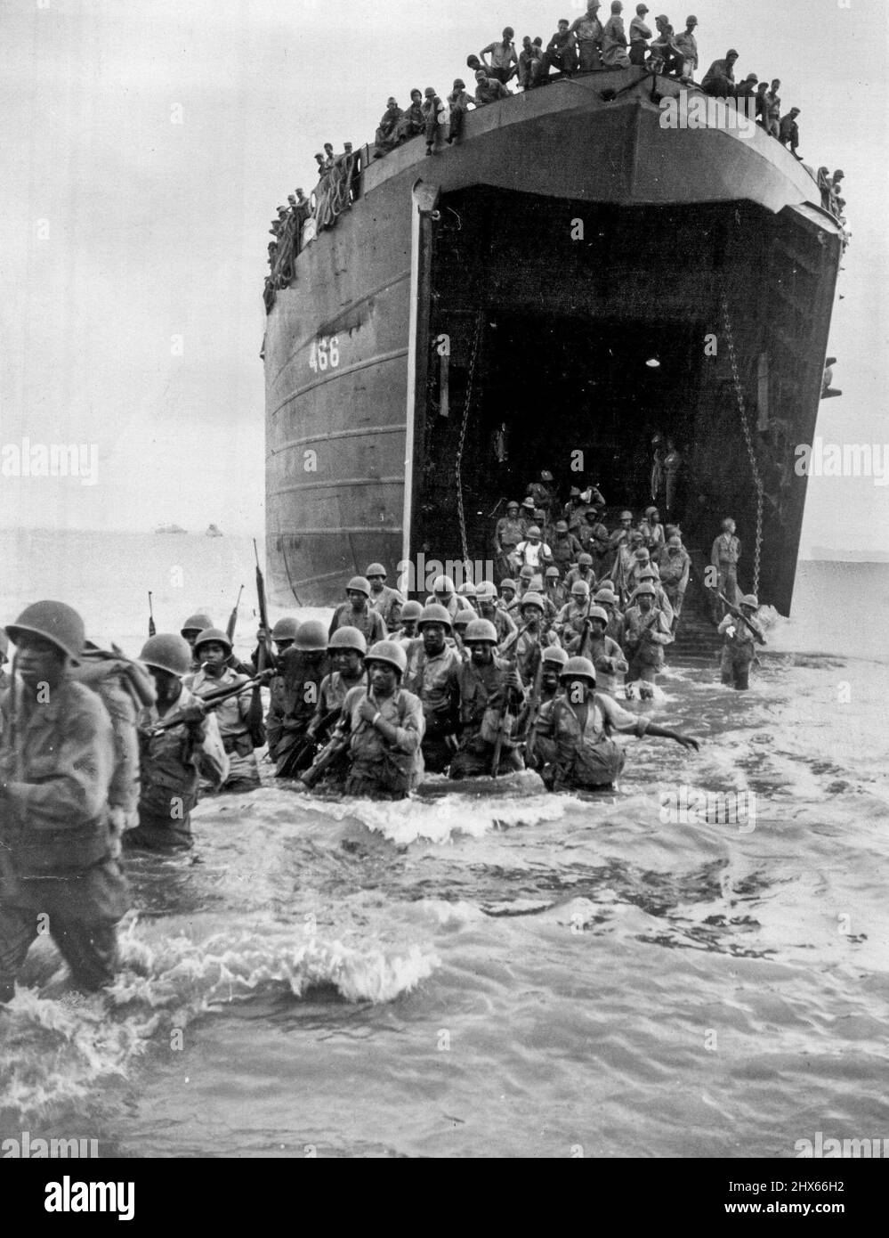 Colored American engineer corps wade ashore at Toam on coast of Dutch New Guinea. The area was occupied against slight Japanese opposition. It was stepping stone in capture of Japanese-held Wakde Island. American troops wading ashore at Toem, then in Dutch New Guinea, in 1944, as a steppingstone operation in the capture of Japanese-held Wakde Island. May 21, 1944. (Photo by Dept. of Information Picture). Stock Photo