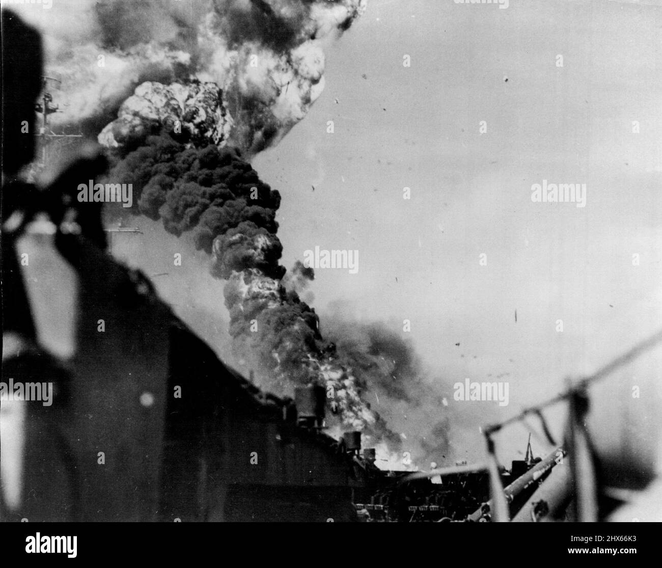 Flame and smoke rise from the deck of the aircraft carrier USS Intrepid after she was struck by a Jap suicide plane off the coast of Luzon on November 25. It was the efforts of her veteran crew that saved the ship from becoming a floating pyre. July 21, 1945. (Photo by Associated Press Photo). Stock Photo
