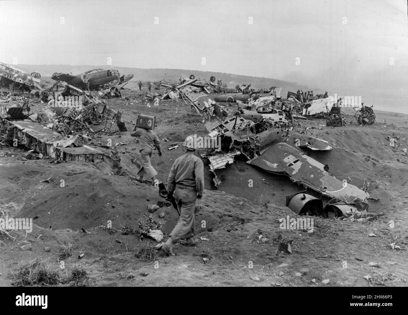 Junkpile Of Wrecked Jap Planes On Iwo -- This Junkpile of wrecked Japanese planes alongside Motoyamo Airstrip No.1 on Iwo Jima represents Havoo wrought by pre-invasion aerial bombings and naval shelling from U.S. forces. This picture was made by Joe Rosenthal Associated Press Staff Photographer on assignment with the wartime still picture pool. March 15, 1945. (Photo by Associated Press Photo). Stock Photo