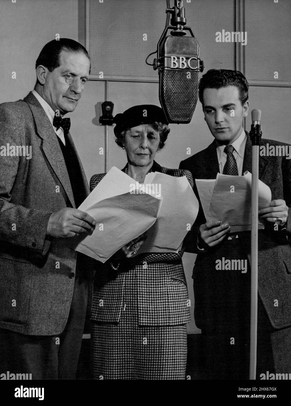 Radio Drama -- Laidman Browne, Gladys Young and David Peel broadcasting in a recent British Broadcasting Corporation production of Shakespeare's 'All's Well That Ends Well'. Laidman Browne and Gladys Young, who recently left the BBC Drama Repertory Company of which they were founder members, are both 'Geordies ', as' natives of England's Tyneside are called. They have made thousands of broadcasts in the past twenty-five years and British people rightly term Gladys Young the First Lady of Radio. Stock Photo