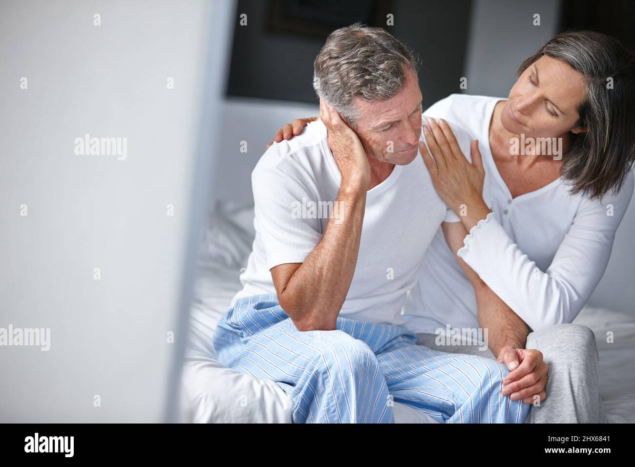 Supporting her husband through a tough time. Shot of a mature woman consoling her husband whos feeling depressed. Stock Photo