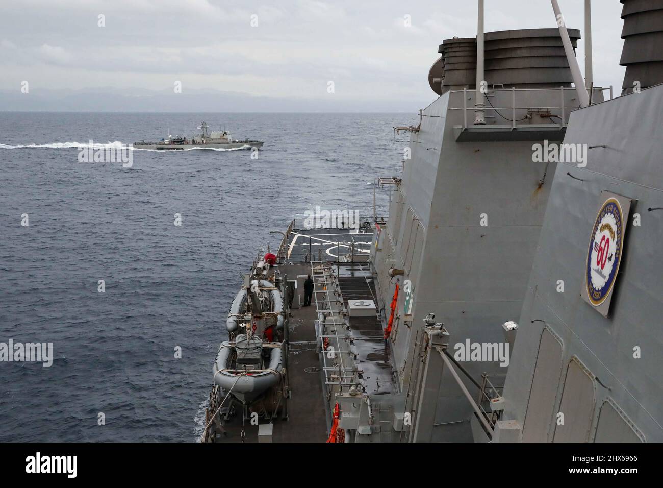220302-N-UN585-1131 LIMASSOL, Cyprus (March 2, 2022) The Cypriot offshore patrol vessel Commodore Andreas Ioannides (P 61), left, conducts naval maneuvering exercises with the Arleigh Burke-class guided-missile destroyer USS Ross (DDG 71) as it leaves port in Limassol, Cyprus, March 2, 2022. Ross, forward-deployed to Rota, Spain, is on its 12th patrol in the U.S. Sixth Fleet area of operations in support of regional allies and partners and U.S. national security interests in Europe and Africa. (U.S. Navy photo by Mass Communication Specialist 2nd Class Claire DuBois/Released) Stock Photo