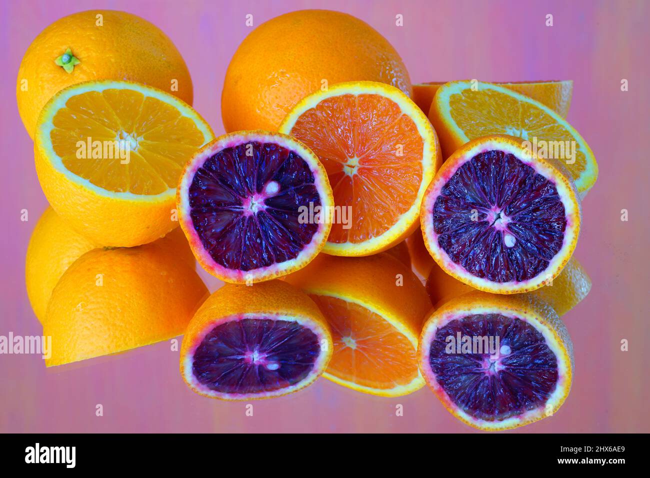 Colorful ruby red blood oranges, navel oranges, and clementines cut in ...