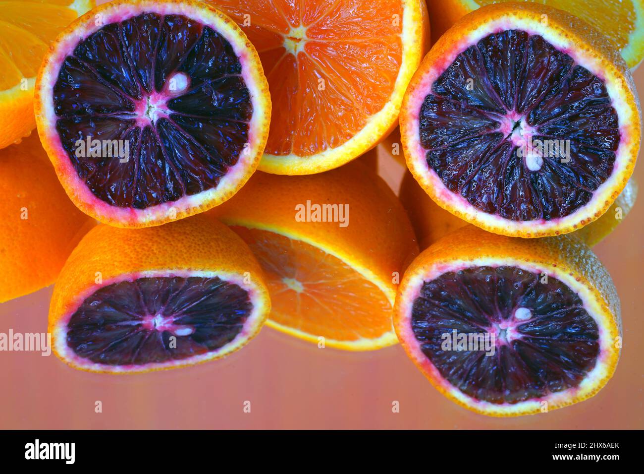 Colorful ruby red blood oranges, navel oranges, and clementines cut in