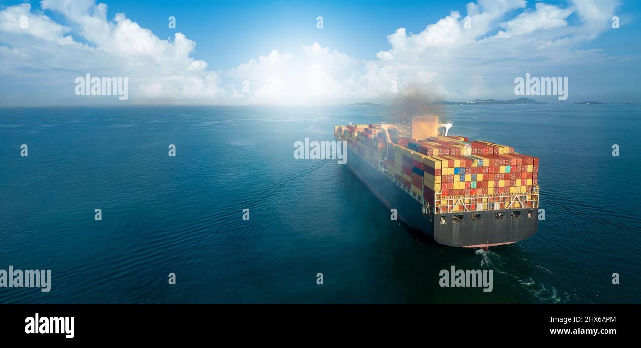 Stern of large cargo ship with Smoke exhaust gas emissions from cargo lagre ship ,Marine diesel enginse exhaust gas from combustion. Stock Photo