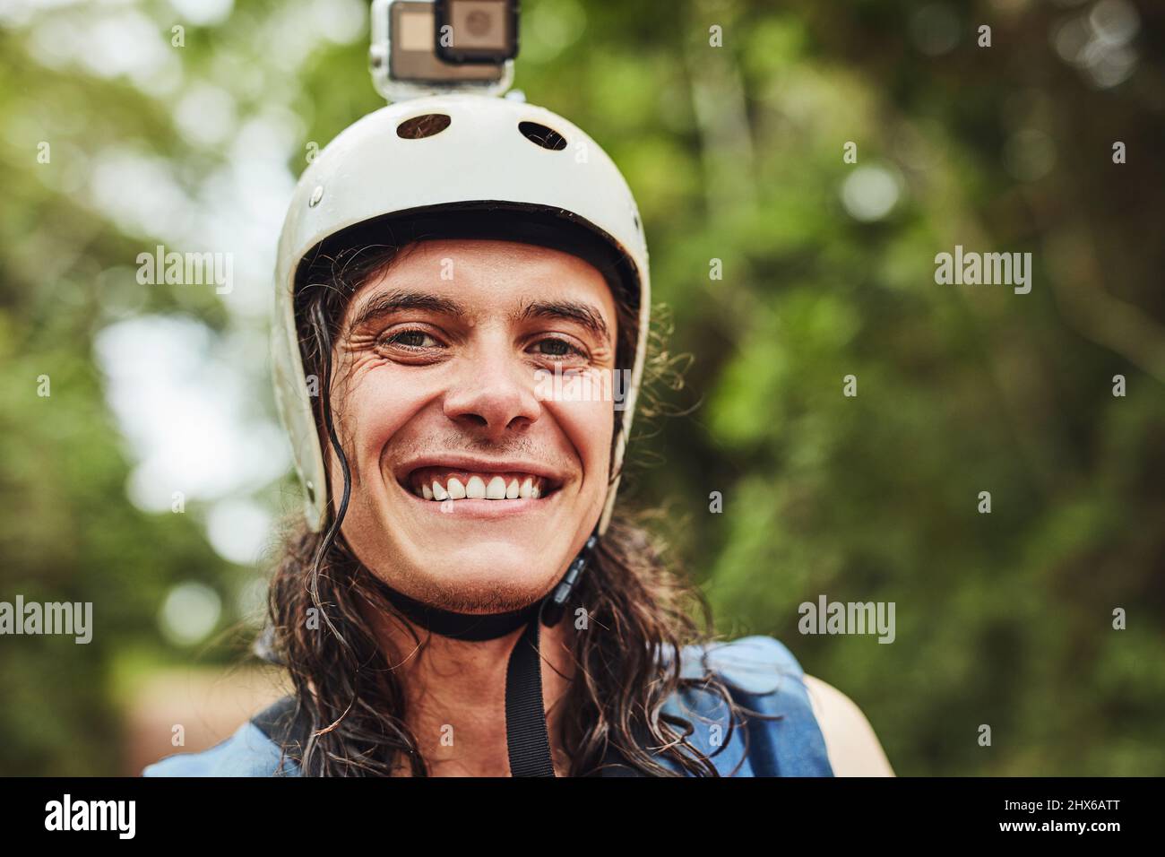 Im ready for an adventure. Cropped shot of an adventurous young man wearing a helmet with a action camera attached. Stock Photo