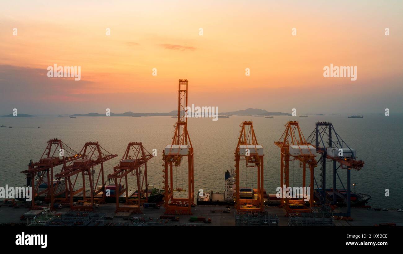 Crane load unload cargo container from truck to cargo ship at in the ...